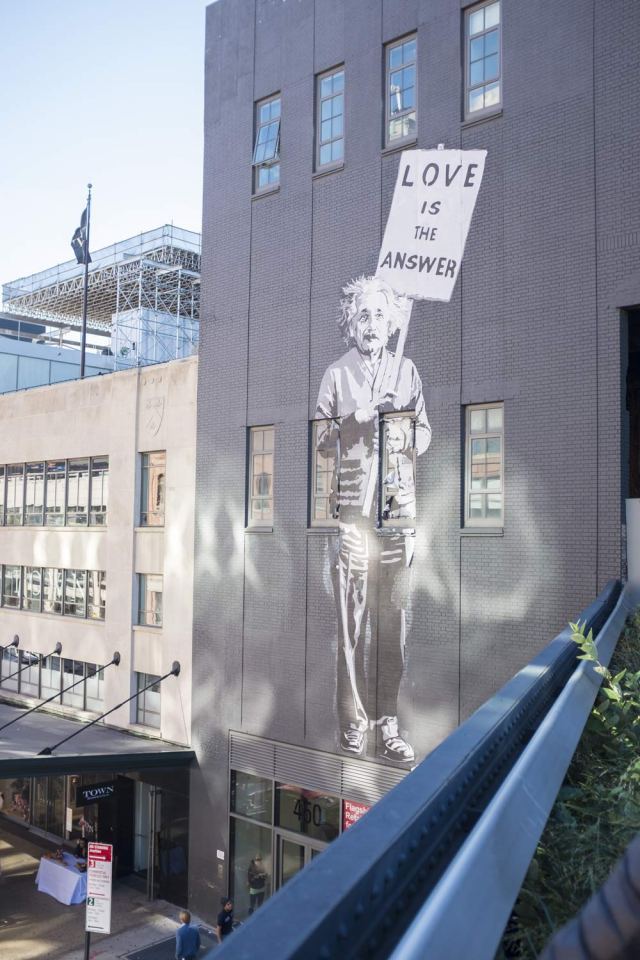 Mural of Einstein holding a poster 'Love Is The Answer' from the High Line in New York