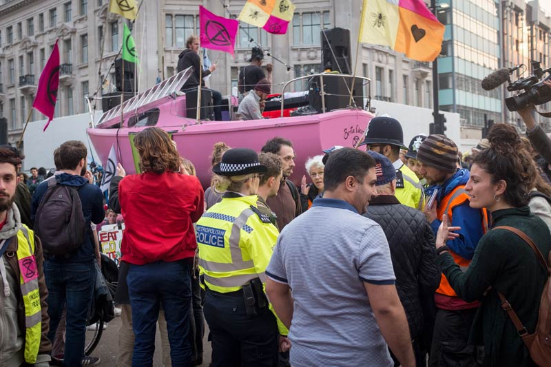 Negotiating with the police before random arrests at the Extinction Rebellion protest at Oxford Circus, London