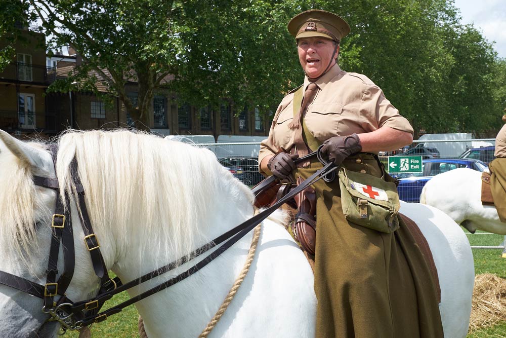 White Highland pony ridder by a woman who is a member of the First Aid Nursing Yeomanry (FANY)