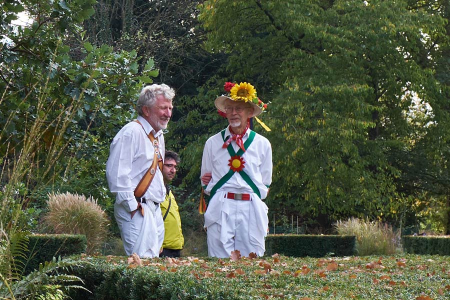 Morris dancers in conversation at Apple Day at the Botanic Gardens in Cambridge - closeup