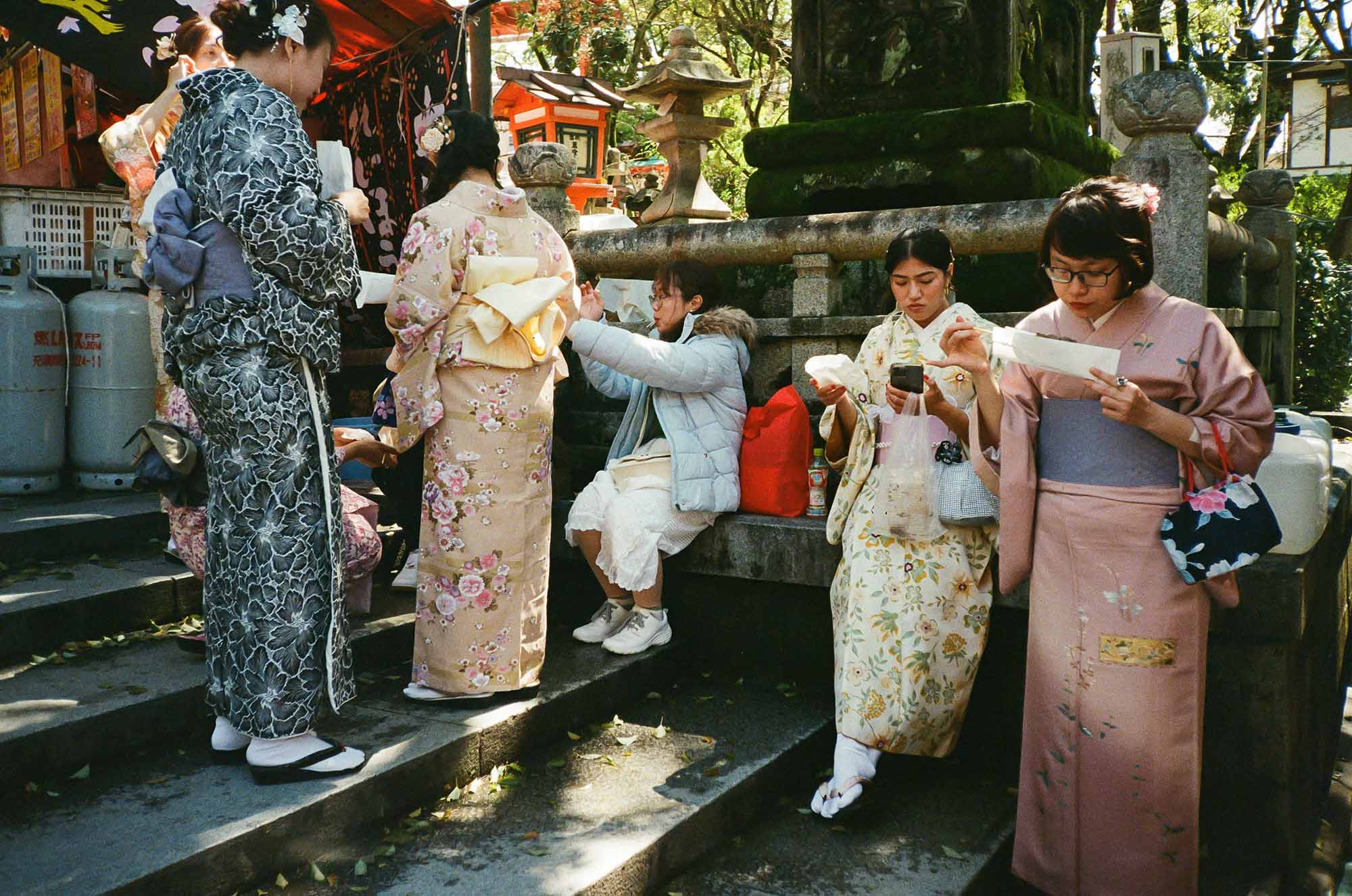women in kimono absorbed in what they are doing