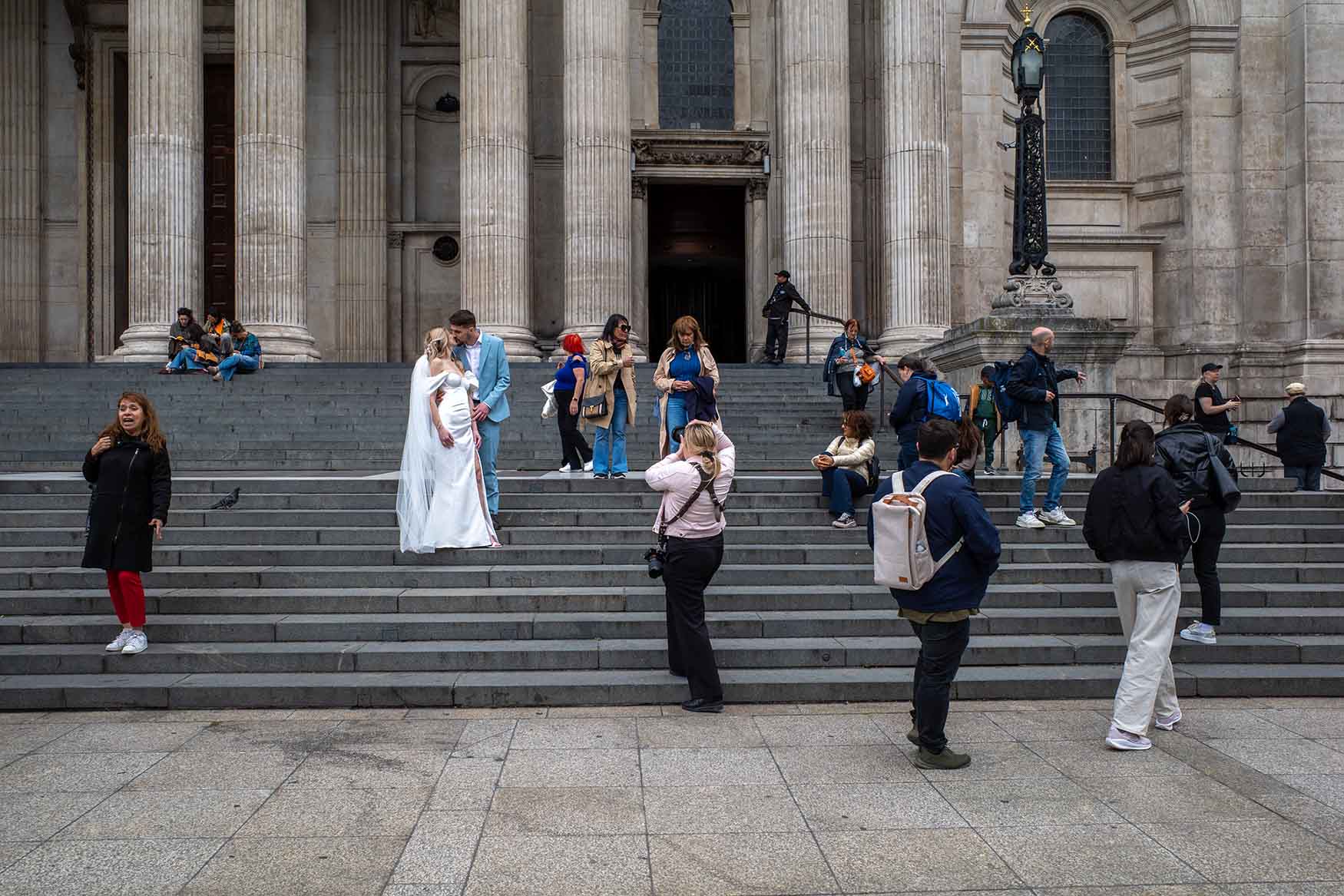 People involved in their own activities on the steps of St Paul's Cathedral