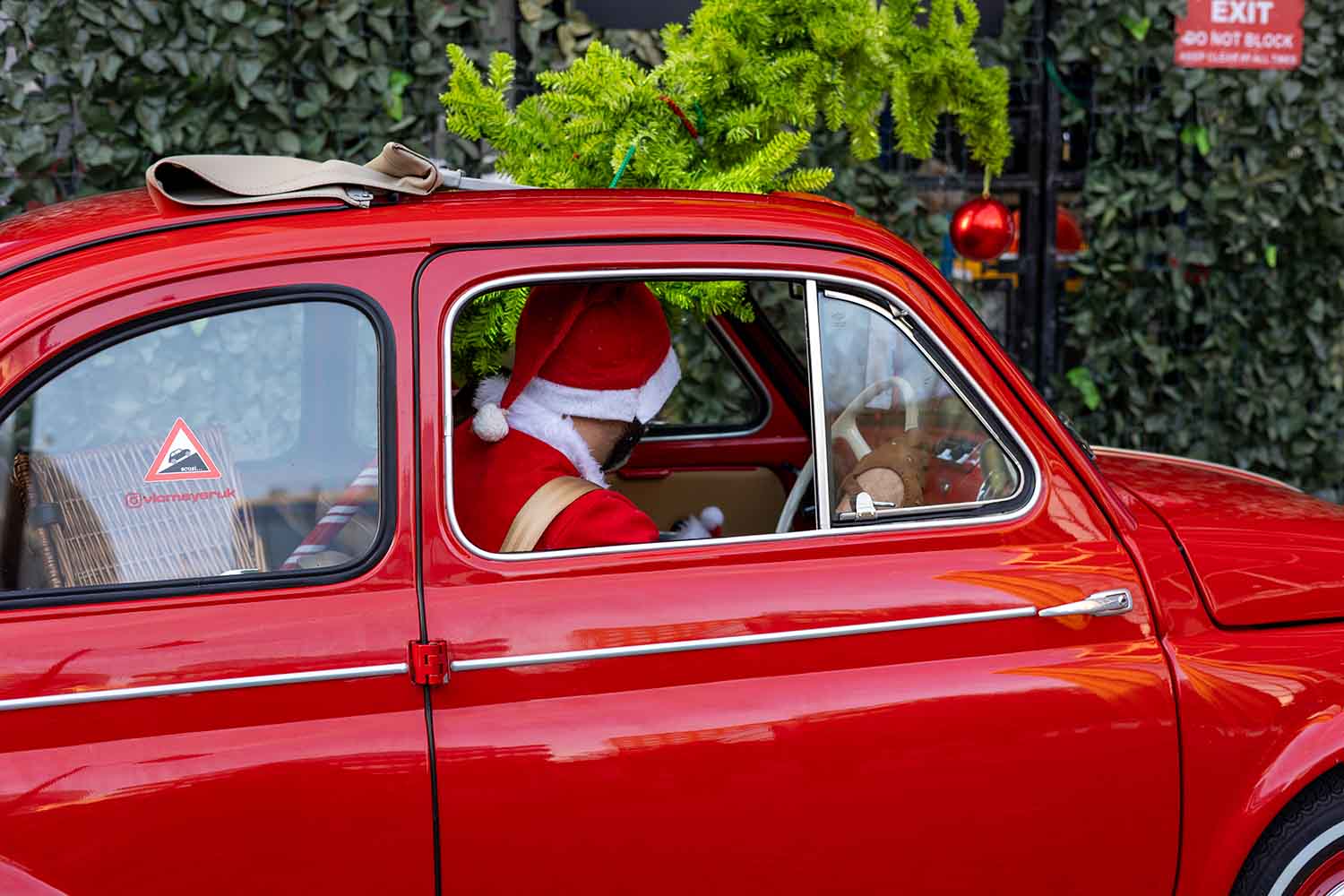 Santa Delivering A Tree in a Fiat 500